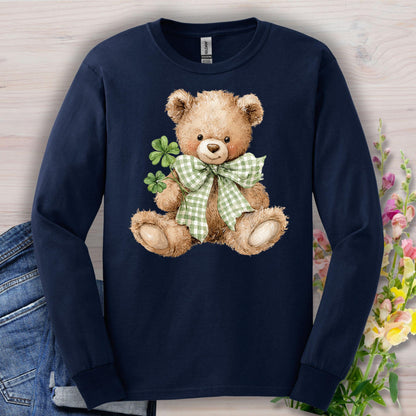 Navy long-sleeve tee with a watercolor teddy bear holding clovers and wearing a green checkered bow.