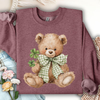 Heather Sport Dark Maroon sweatshirt with a watercolor teddy bear holding four-leaf clovers and wearing a green gingham bow.