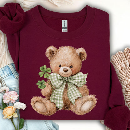 Maroon S sweatshirt with a watercolor teddy bear holding shamrocks and wearing a green plaid bow.