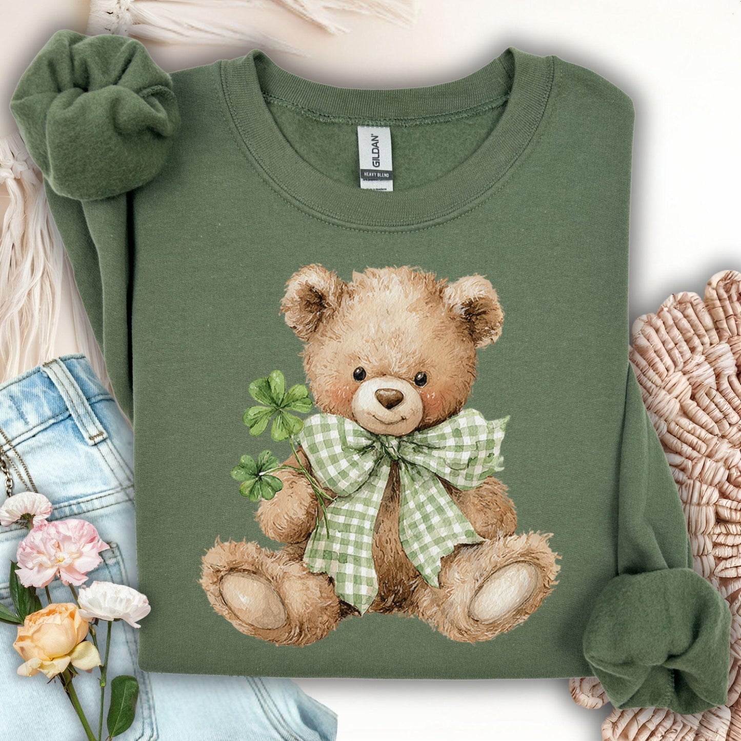 Military Green S sweatshirt with a watercolor teddy bear holding shamrocks and wearing a green gingham bow.