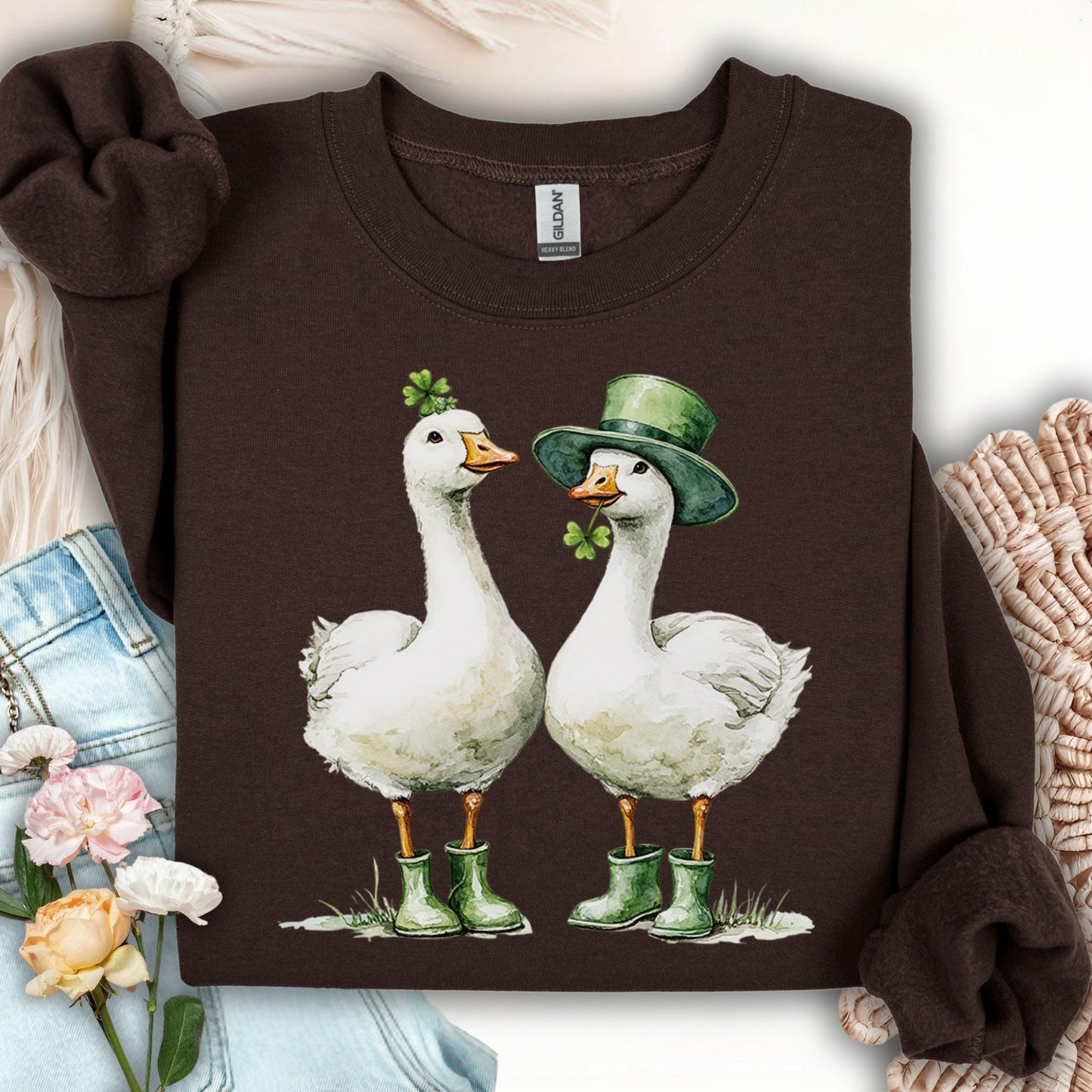 Dark chocolate sweatshirt with two geese in green boots and St. Patrick's Day shamrock hats.