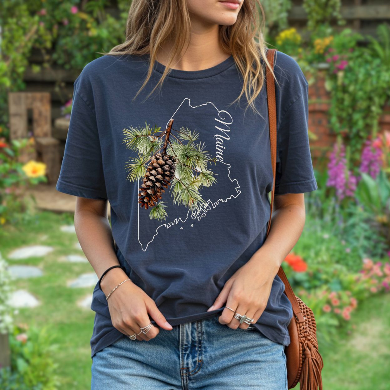 Relaxed-fit, garment-dyed navy t-shirt with a pine cone and Maine outline graphic.