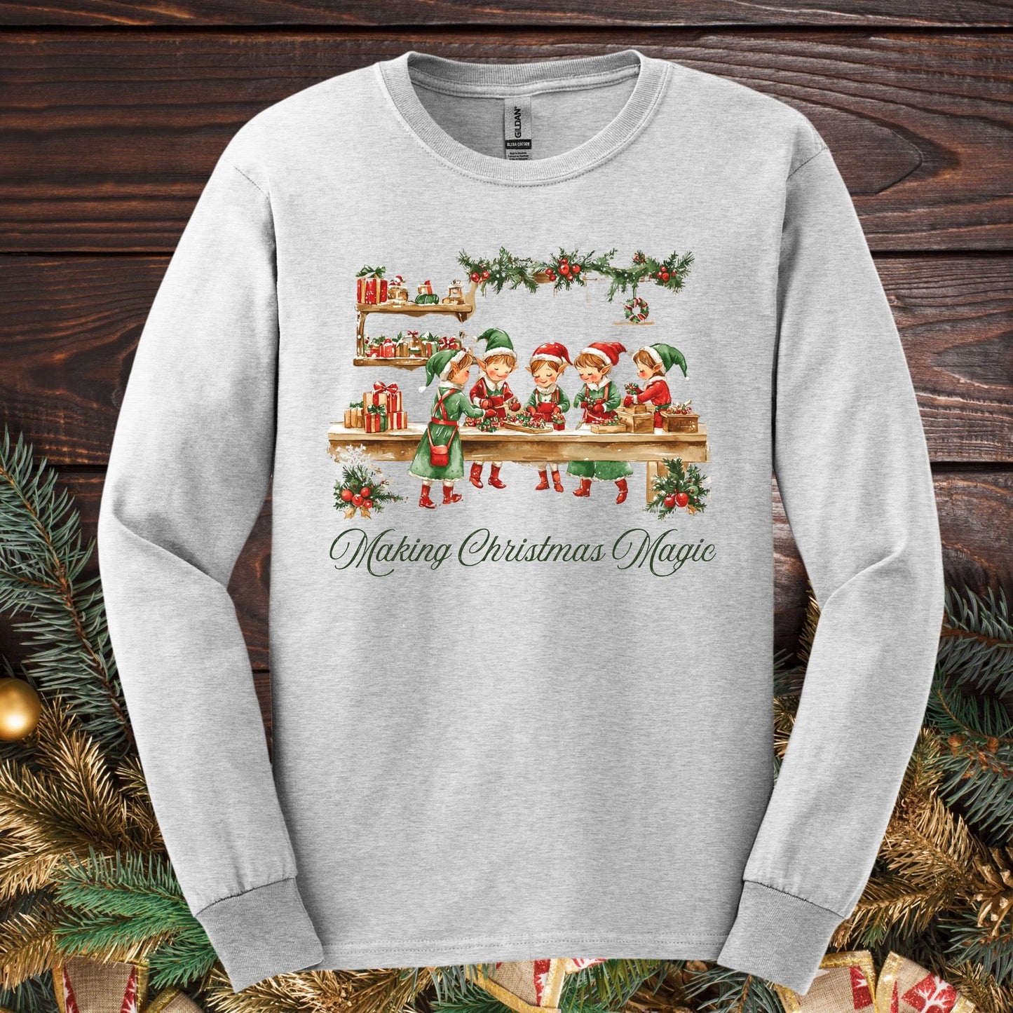 Ash long sleeve tee with vintage Santa's workshop, elves, and "Making Christmas Magic" text.