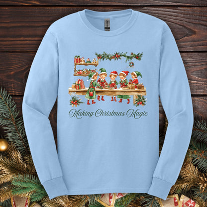 Light blue long sleeve tee with vintage Santa's workshop elves and "Making Christmas Magic" text.