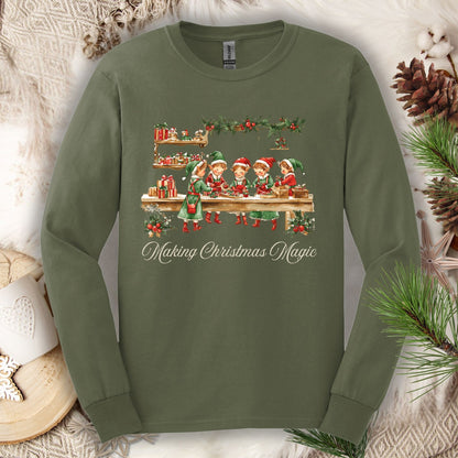 Military Green long sleeve tee with vintage Santa's workshop elves and "Making Christmas Magic" text.