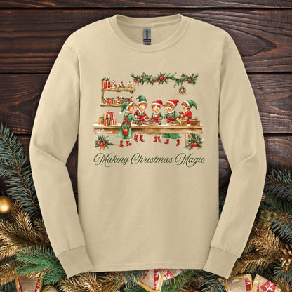 Sand long sleeve tee with vintage Santa's workshop, elves, and "Making Christmas Magic" text.