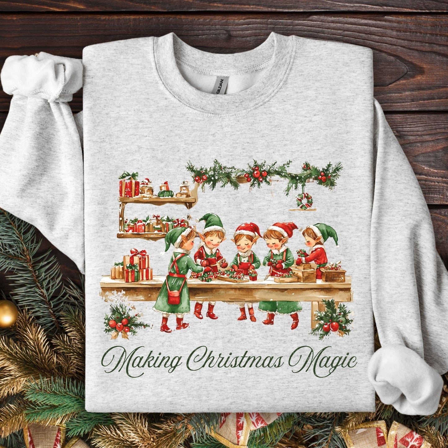 Ash grey S sweatshirt with vintage Santa workshop elves and "Making Christmas Magic" text.