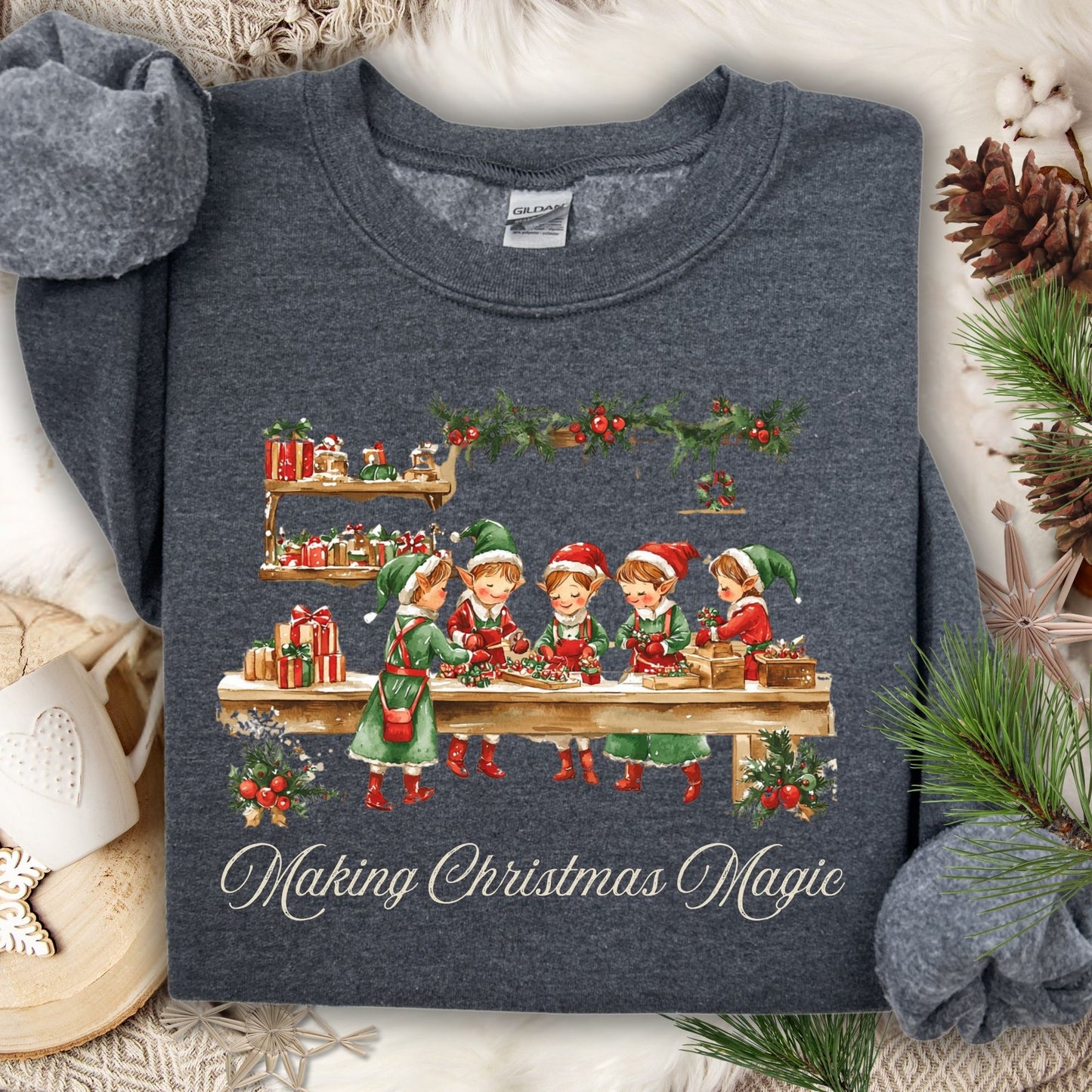 Dark Heather S sweatshirt with vintage Santa's workshop, elves, and "Making Christmas Magic" design.