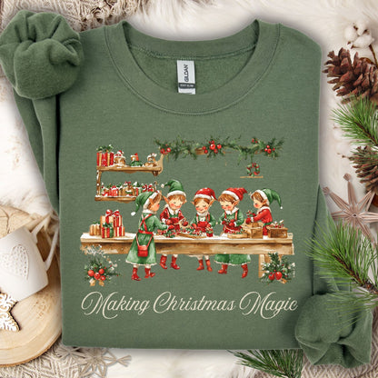 Military Green S sweatshirt with vintage Santa's workshop elves and "Making Christmas Magic" text.