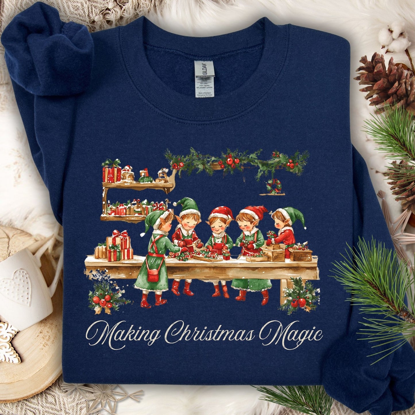 Navy S sweatshirt with "Making Christmas Magic" and vintage elves in Santa's workshop design.