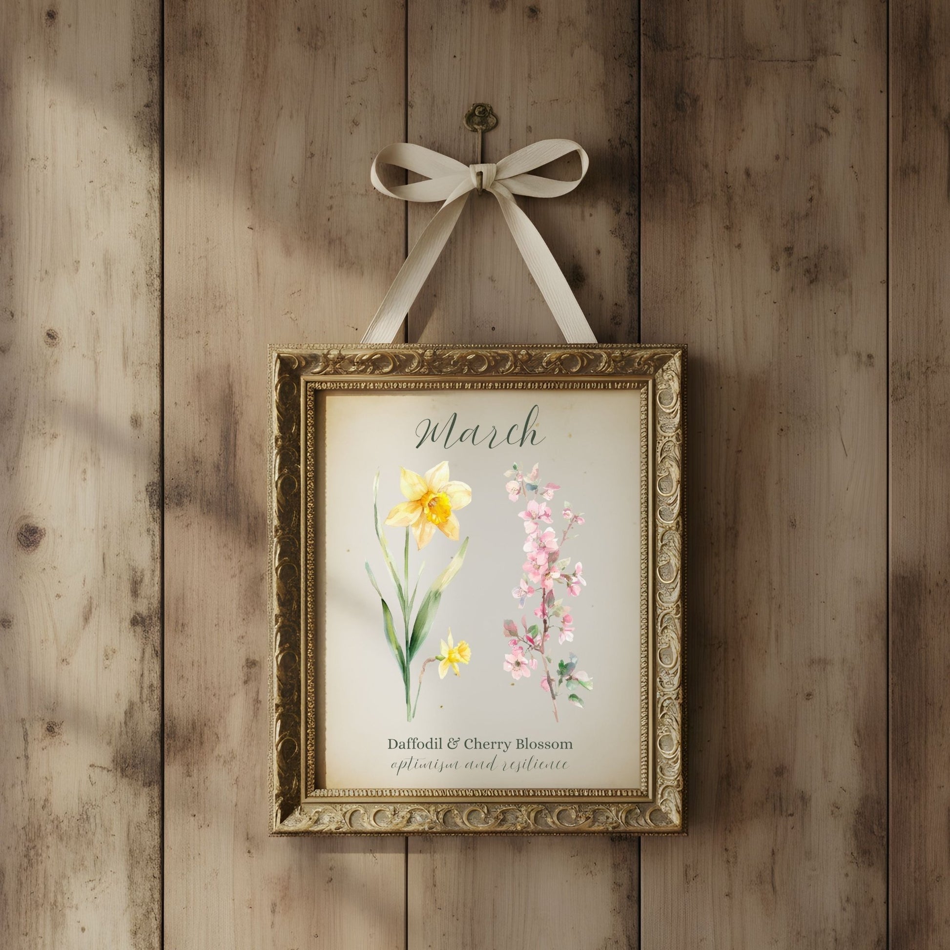 Watercolor March birth month flower art print with daffodil and cherry blossom in a gold frame.