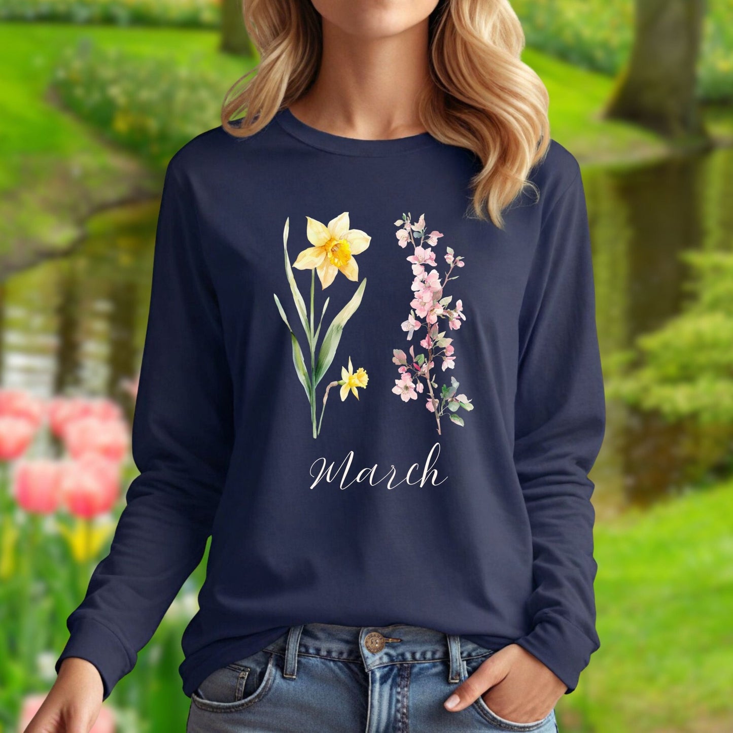 Navy long-sleeve tee with hand-drawn daffodil, pink cherry blossoms, and "March" script.