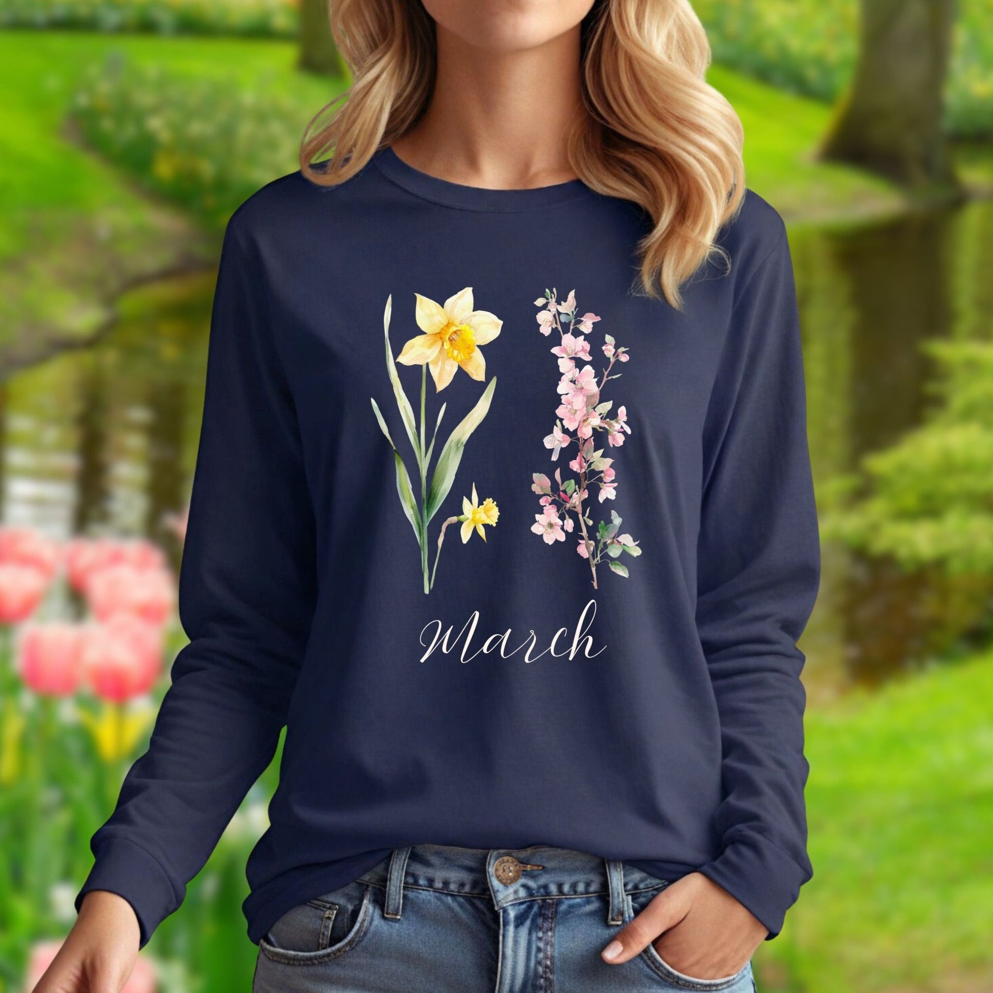 Navy long-sleeve tee with hand-drawn daffodil, pink cherry blossoms, and "March" script.