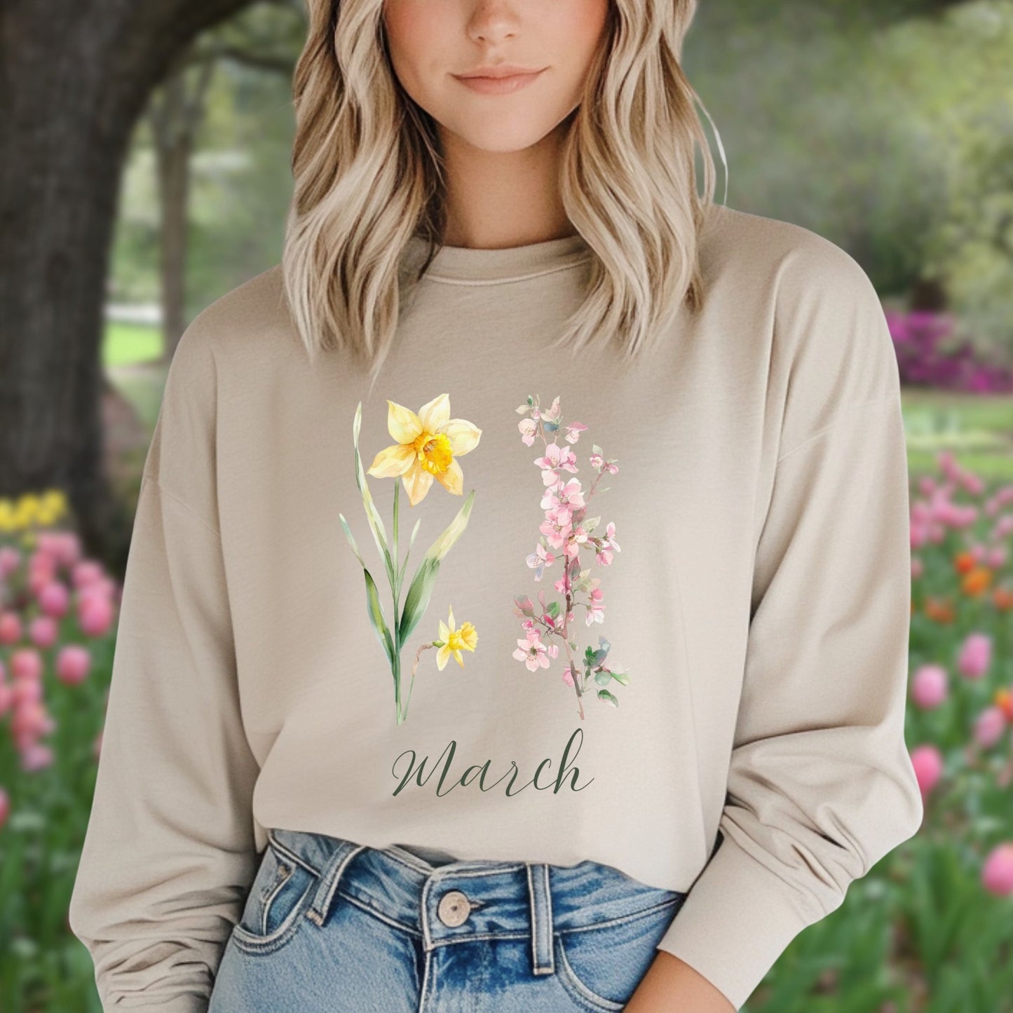 Beige long sleeve tee with hand-drawn yellow daffodils, pink cherry blossoms, and "March" script.