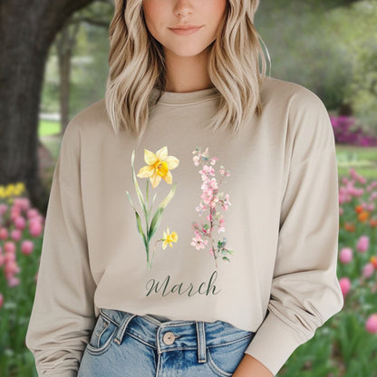 Beige long sleeve tee with hand-drawn yellow daffodils, pink cherry blossoms, and "March" script.
