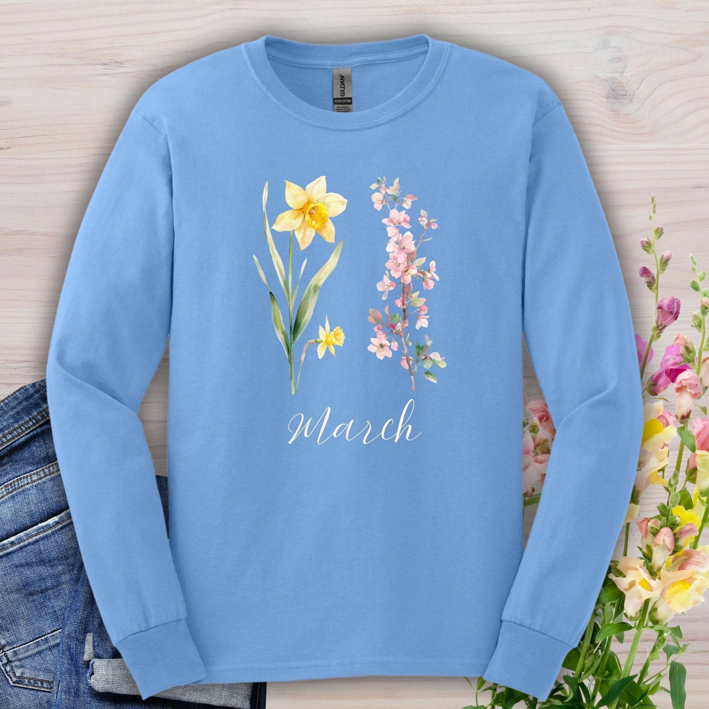Carolina Blue long sleeve tee with hand-drawn daffodil, pink cherry blossoms, and "March" script.