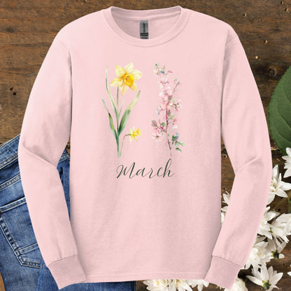 Light pink long-sleeve cotton tee with hand-drawn daffodil and cherry blossom art, plus "March" script.