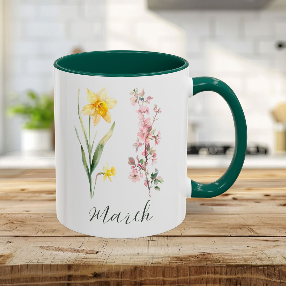 White ceramic mug with green handle and interior, featuring watercolor daffodils, cherry blossoms, and "March" text.