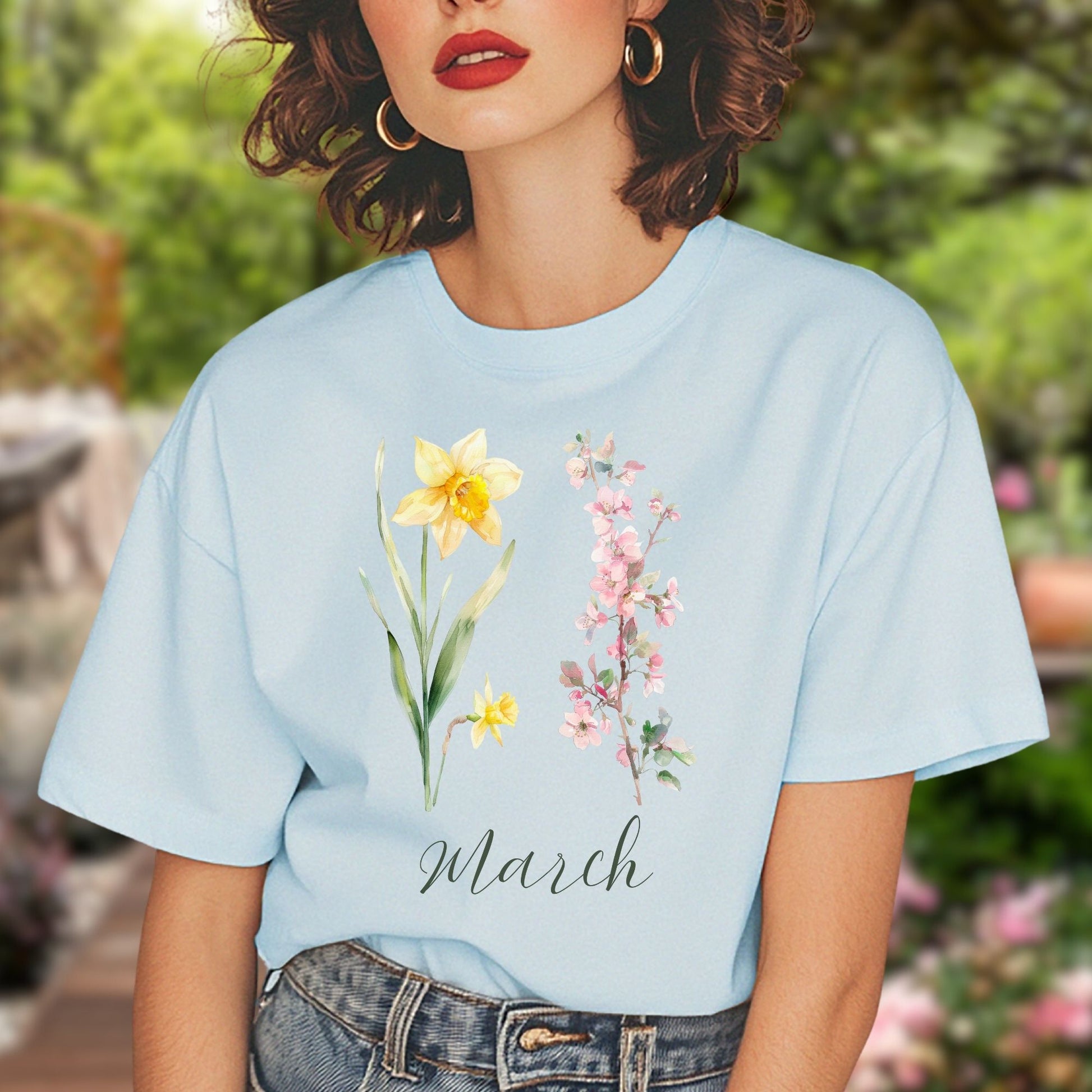 Light blue cotton t-shirt with watercolor daffodil, cherry blossoms, and "March" script.