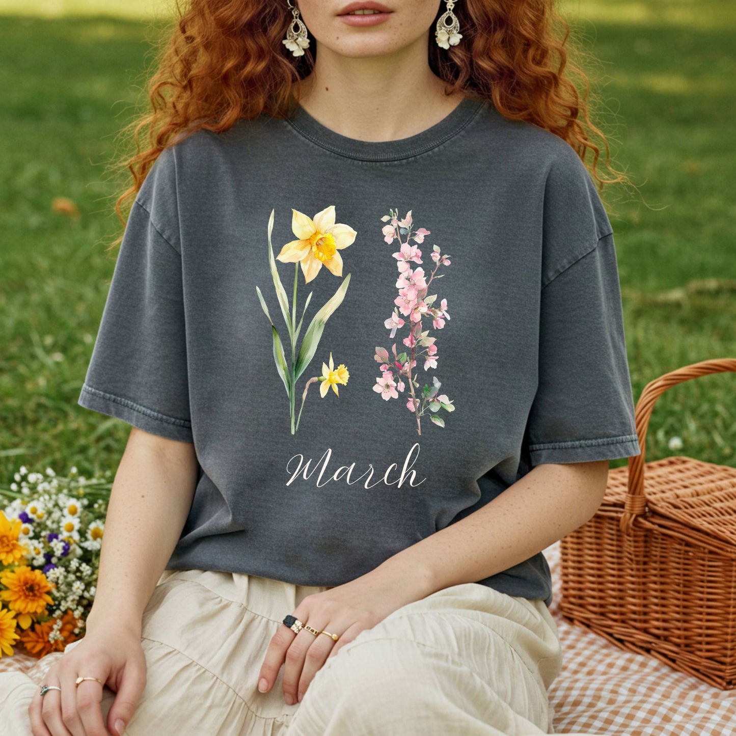 Garment-dyed charcoal t-shirt with watercolor daffodils, cherry blossoms, and "March" script.