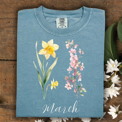 Ice Blue March Birth Month T-Shirt with watercolor daffodil and cherry blossoms.