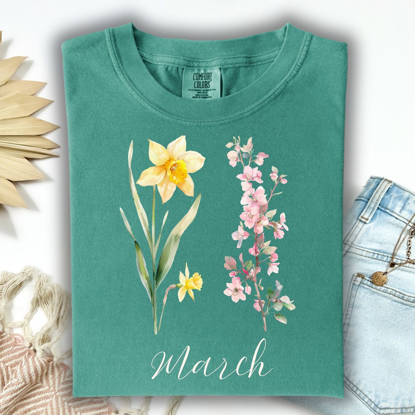 Seafoam S t-shirt with watercolor daffodil, cherry blossoms, and "March" script.