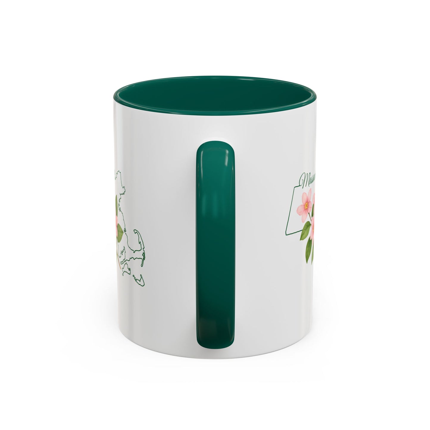White ceramic mug with a green handle and interior, featuring a Massachusetts state outline and pink Mayflower blossoms.