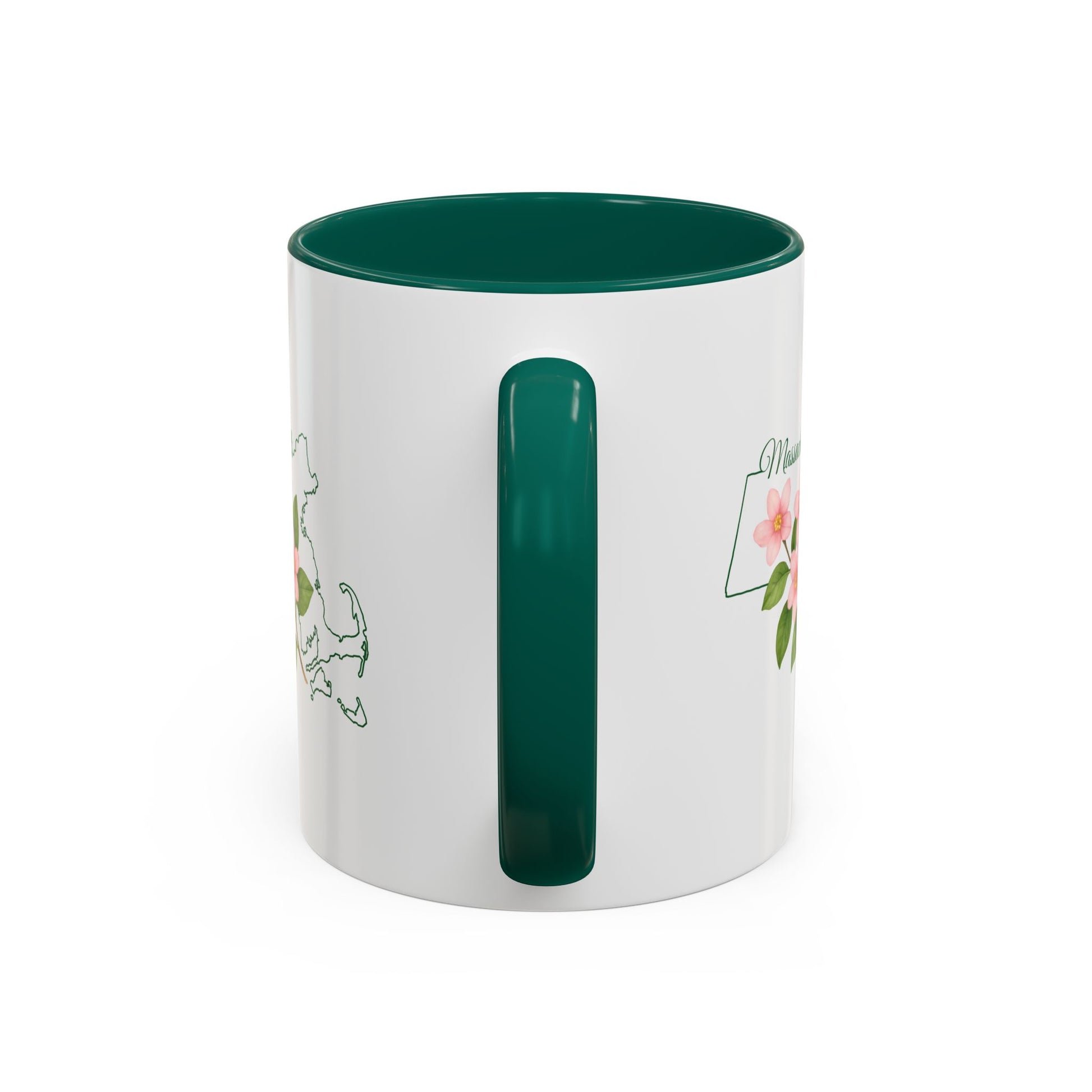 White ceramic mug with a green handle and interior, featuring a Massachusetts state outline and pink Mayflower blossoms.