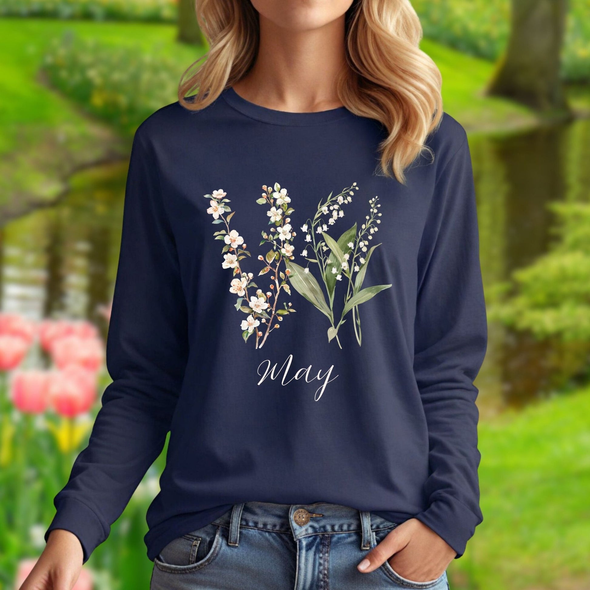 Navy long sleeve tee with watercolor lily of the valley and hawthorn blossoms, "May" script.
