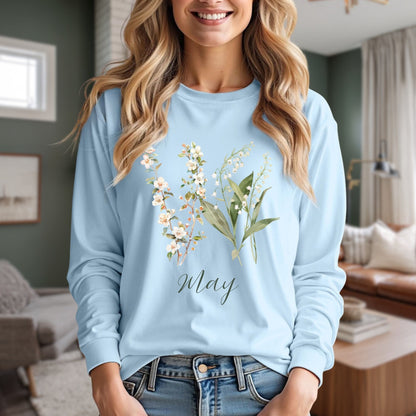 Light blue long-sleeve tee with watercolor lily of the valley and hawthorn blossoms, "May" script.