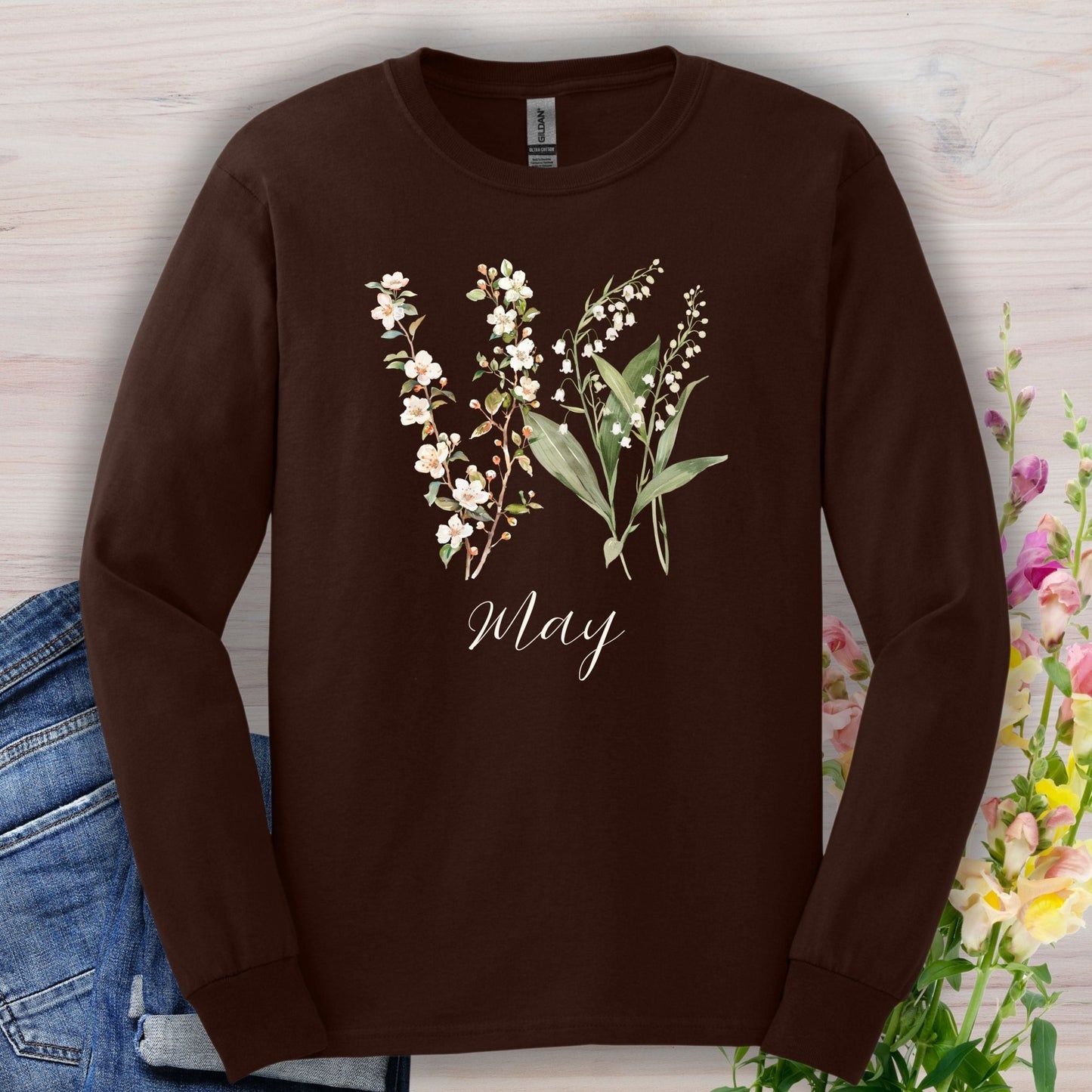 Dark chocolate long sleeve tee with watercolor lily of the valley, hawthorn blossoms, and "May" script.