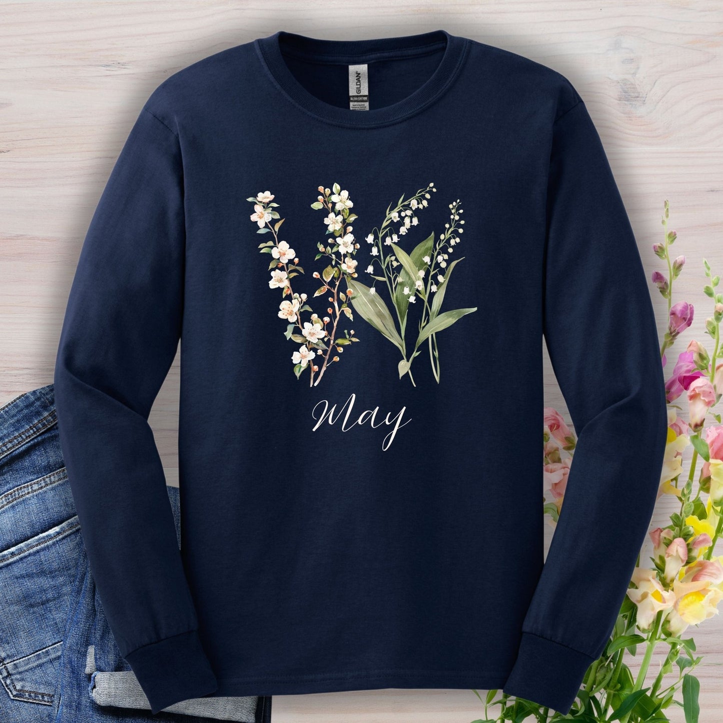 Navy long sleeve tee with watercolor lily of the valley and hawthorn blossoms, "May" script.
