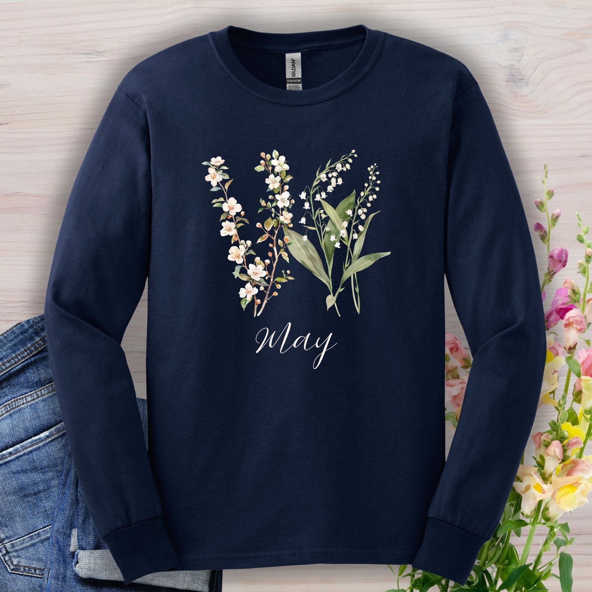Navy long sleeve tee with watercolor lily of the valley and hawthorn blossoms, "May" script.