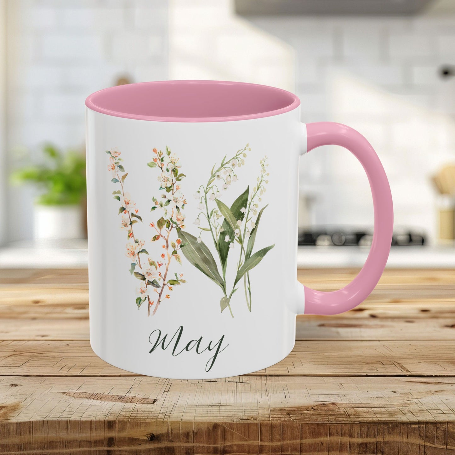 11oz May Birth Month Flower Mug with pink handle and interior, featuring watercolor lily of the valley and hawthorn sprigs.