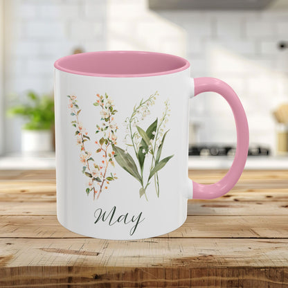 11oz May Birth Month Flower Mug with pink handle and interior, featuring watercolor lily of the valley and hawthorn sprigs.