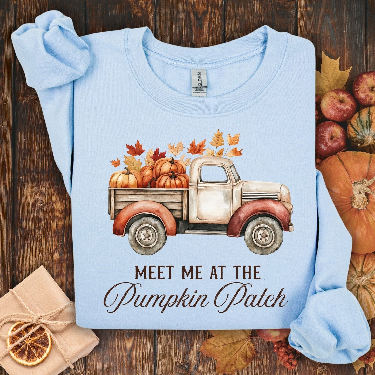 Light blue Gildan sweatshirt with a vintage truck, pumpkins, and "Meet Me at the Pumpkin Patch" text.