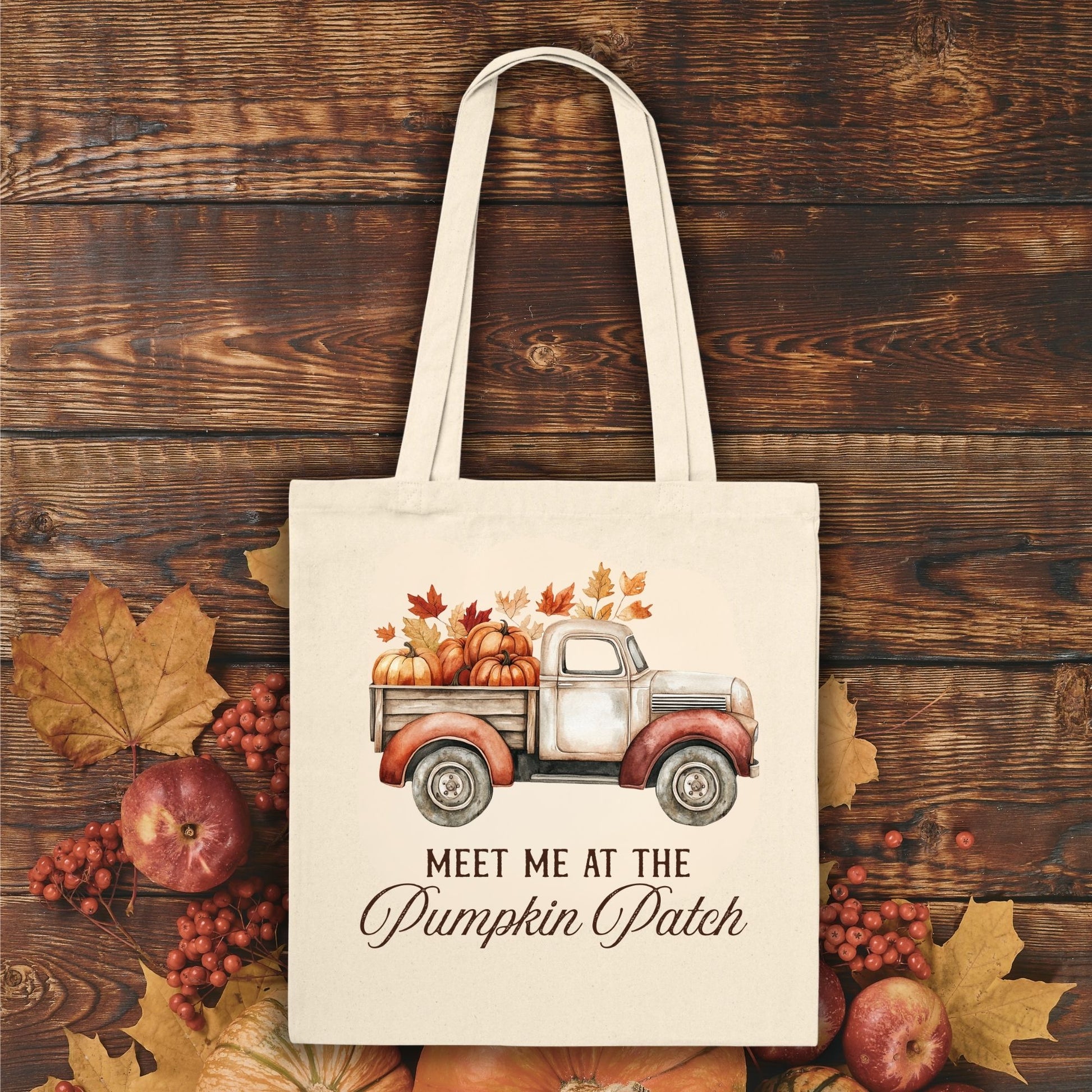 Natural canvas tote bag with vintage truck, pumpkins, fall leaves, and "Meet Me at the Pumpkin Patch" text.