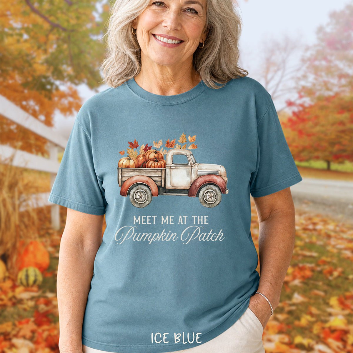 Ice blue garment-dyed cotton t-shirt featuring a watercolor vintage truck with pumpkins and autumn leaves graphic.