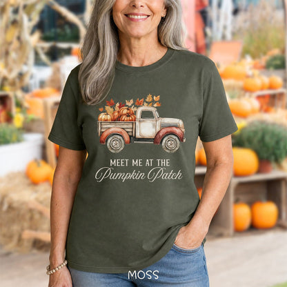 Moss green relaxed-fit cotton t-shirt featuring a watercolor vintage truck filled with pumpkins and autumn leaves.
