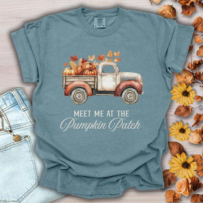 Ice blue garment-dyed cotton t-shirt featuring a watercolor vintage truck with pumpkins and autumn leaves, size small.