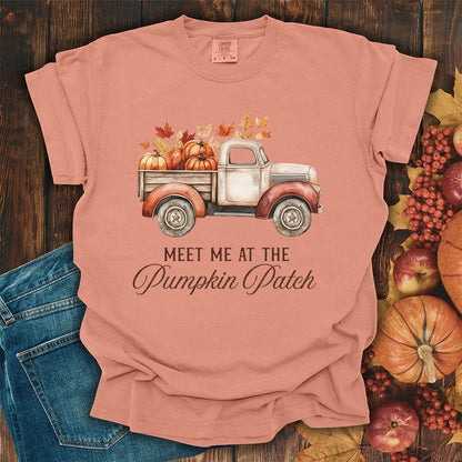 Terracotta garment-dyed cotton t-shirt featuring a watercolor vintage truck filled with pumpkins and autumn leaves.