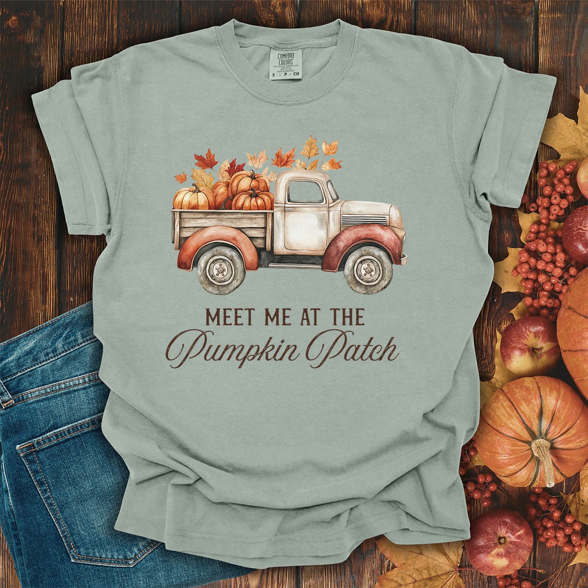 Bay-colored, garment-dyed cotton t-shirt featuring a watercolor vintage truck with pumpkins and autumn leaves.