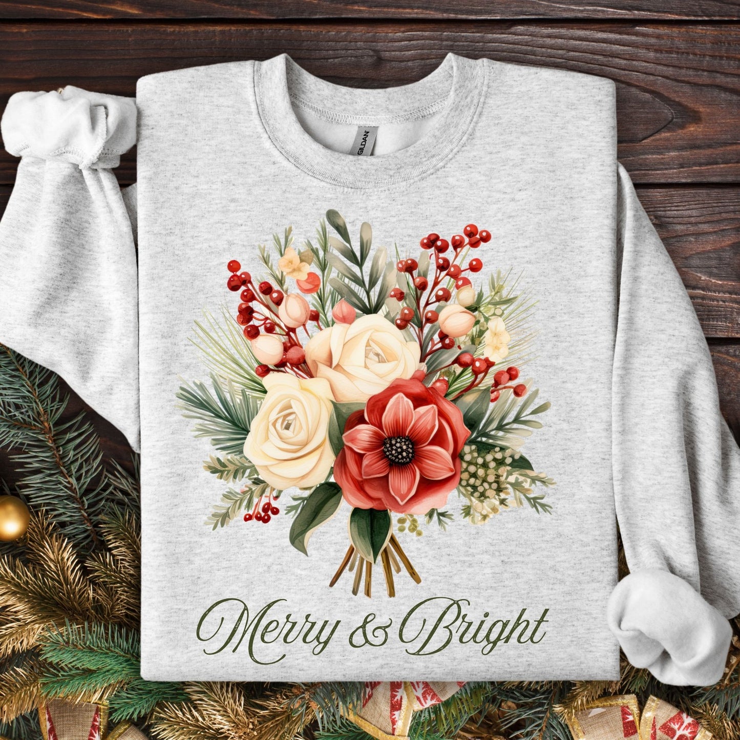 Ash gray Gildan sweatshirt with vintage poinsettia and rose bouquet, "Merry & Bright" text, and holiday foliage.