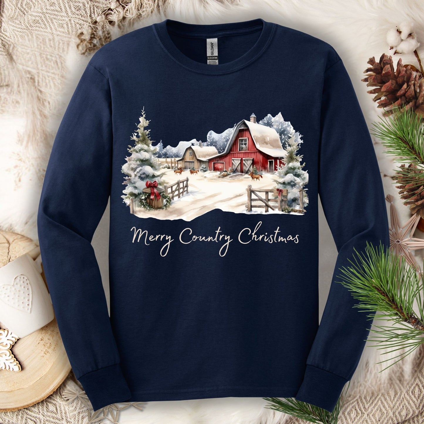 Navy long sleeve tee with a snowy red barn, festive greenery, and "Merry Country Christmas" text.
