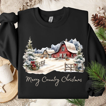 Black Gildan sweatshirt with a watercolor design of a snow-covered red barn, evergreens, and "Merry Country Christmas.