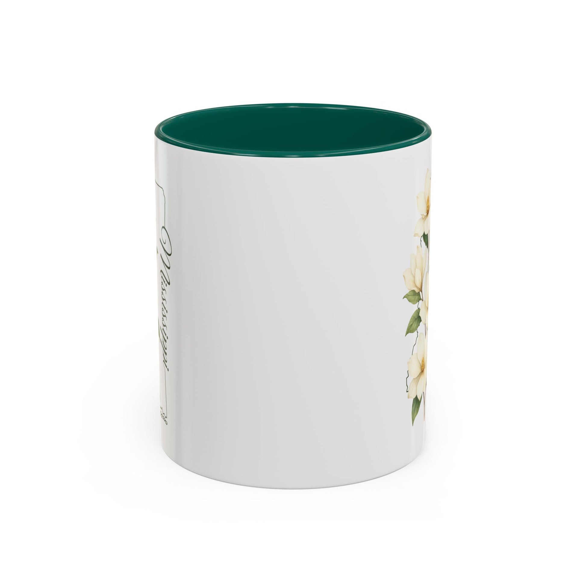 White ceramic mug with green interior, featuring delicate magnolia blooms and a Mississippi state outline.