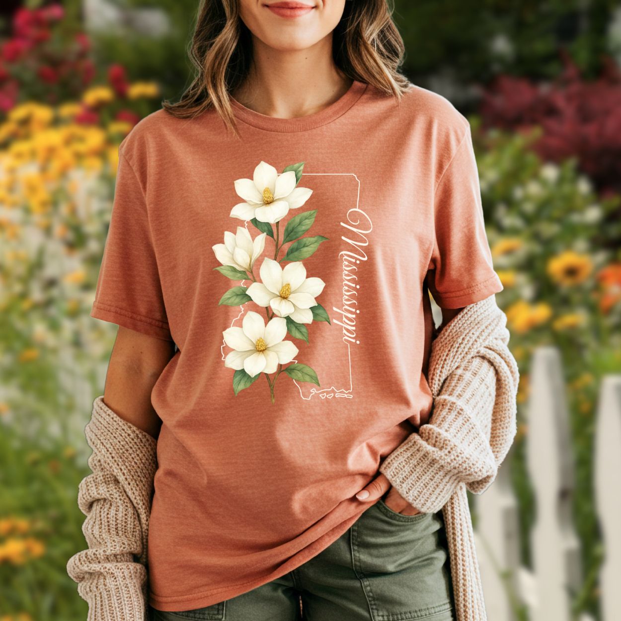 Garment-dyed, relaxed-fit terracotta t-shirt with a magnolia illustration and "Mississippi" text.