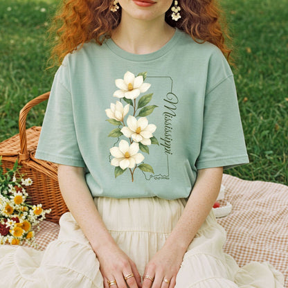 Relaxed-fit, garment-dyed sage green cotton t-shirt featuring a magnolia illustration and "Mississippi" text.