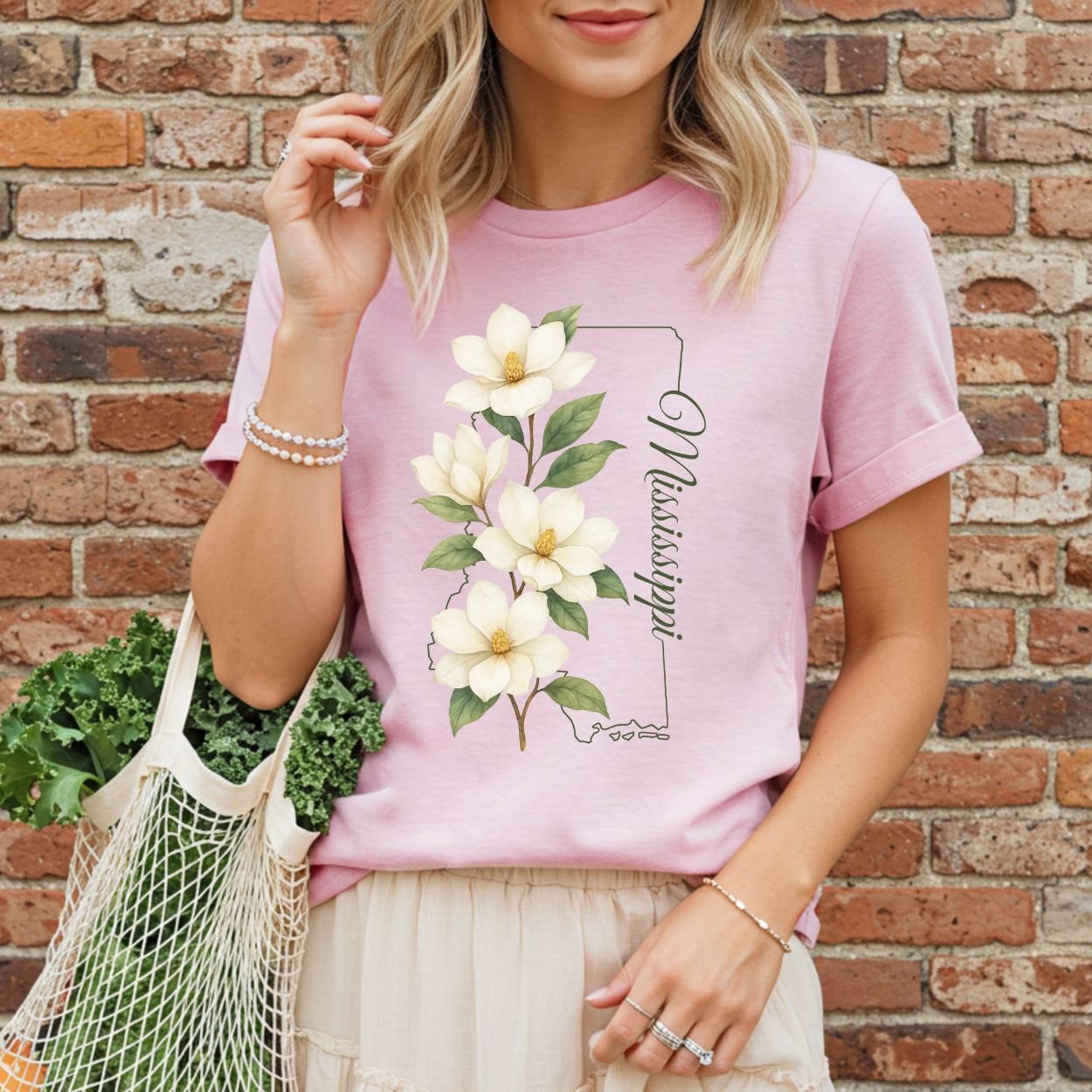Relaxed-fit, garment-dyed pink cotton t-shirt with a magnolia illustration and Mississippi state outline.
