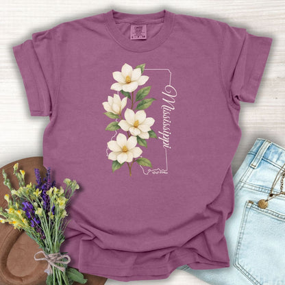 Berry S-sized garment-dyed cotton t-shirt with a white magnolia illustration and Mississippi state outline.